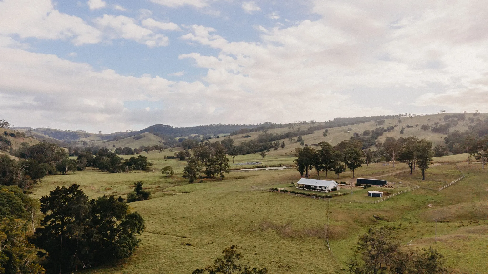 Wallaringa Farm countryside and accommodation surrounded by rolling green hills