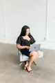LRC Social founder working on a laptop in a studio chair